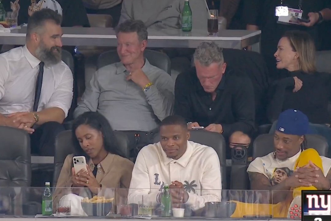 Pat McAfee gets lost in his phone while Jason Kelce keeps the VIP suite entertained during Monday Night Football