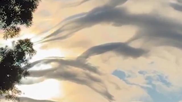A rare wave-like cloud formation called “asperitas” wowed residents as it filled the sky above...